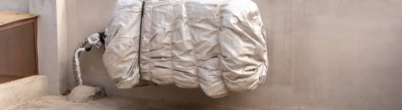 tarp wrapped around an ac unit outdoor